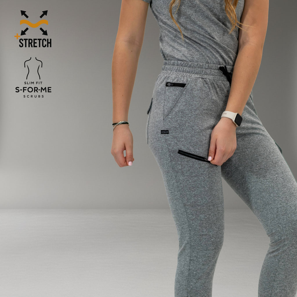Detalle del jogger gris jaspeado: cordón de cintura y bolsillos de muslo con cierres en contraste.