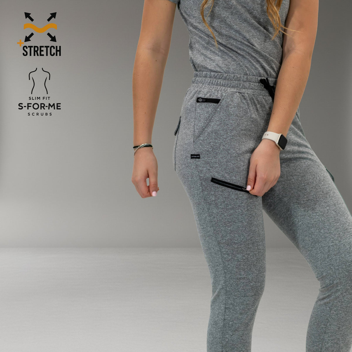 Detalle del jogger gris jaspeado: cordón de cintura y bolsillos de muslo con cierres en contraste.
