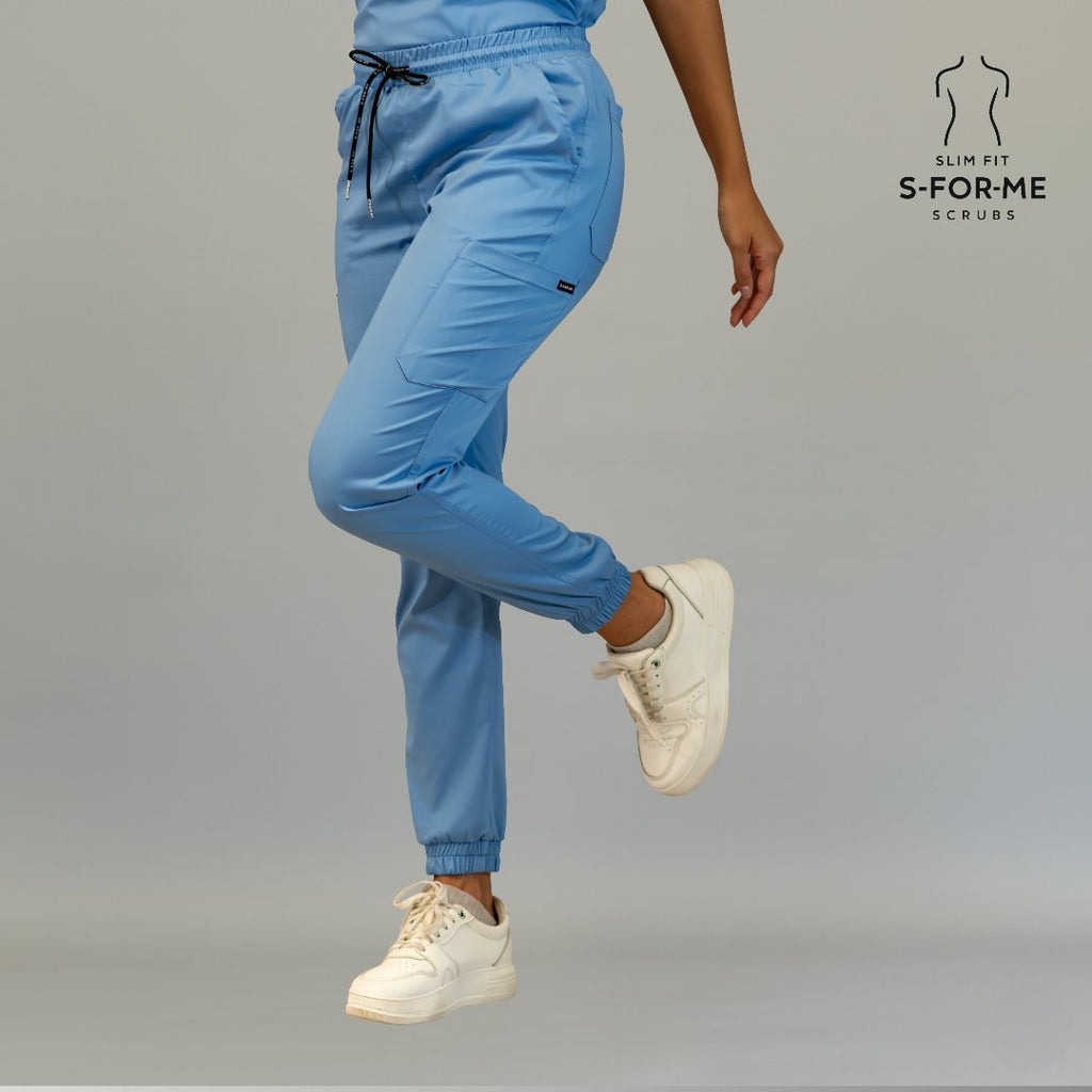 Women’s ceil blue Butter-Soft scrub joggers showing flexible movement and ankle cuffs