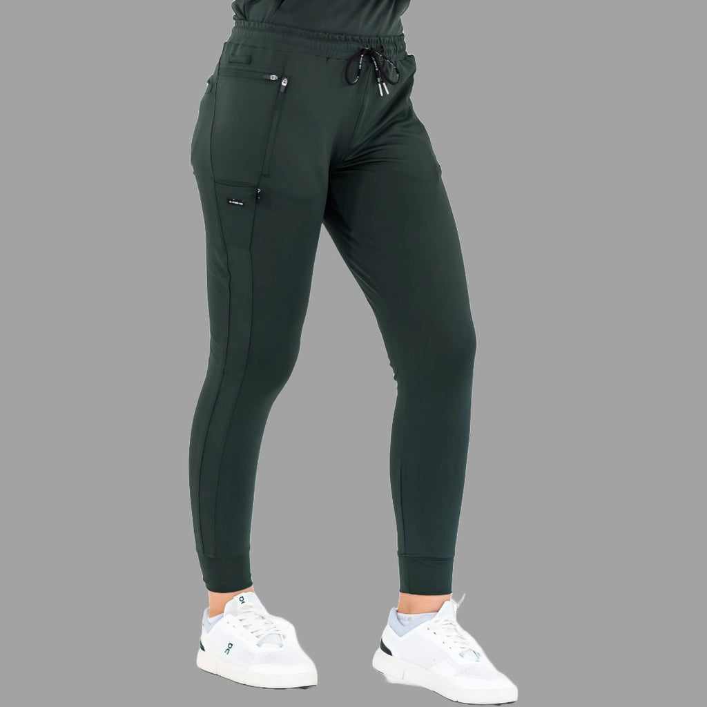 Three-quarter view of women's scrub joggers 920 super stretch bottle green in a standing pose.