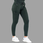 Three-quarter view of women's scrub joggers 920 super stretch bottle green in a standing pose.