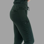 Close-up side view of women's scrub joggers 920 super stretch bottle green showing side cargo pocket.