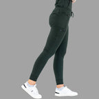 Back view of women's scrub joggers 920 super stretch bottle green with legs spread apart.