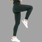 Side view of women's scrub joggers 920 super stretch bottle green with one leg raised.
