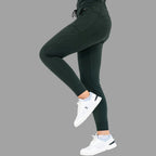 Side view of women's scrub joggers 920 super stretch bottle green showing a walking pose.
