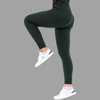 Back side view of women's scrub joggers 920 super stretch bottle green with one leg lifted.