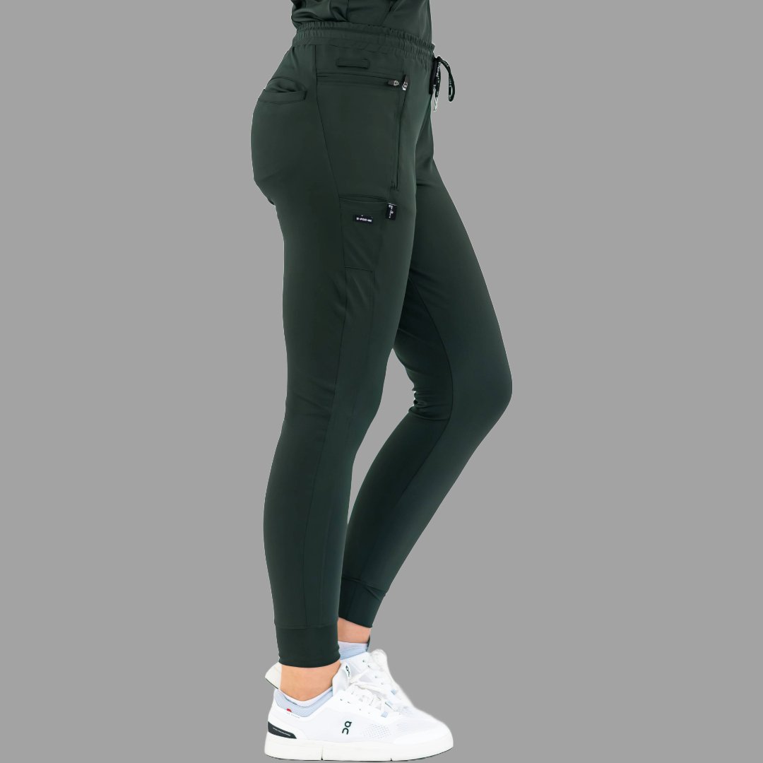 Three-quarter view of women's scrub joggers 920 super stretch bottle green showing side pockets.