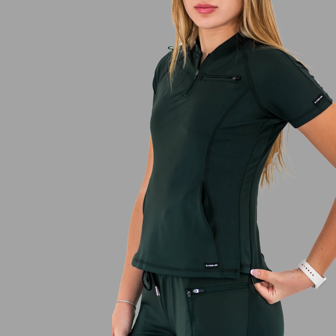 Close up side angle of the bottle green 920 super stretch scrub top showing the fit.