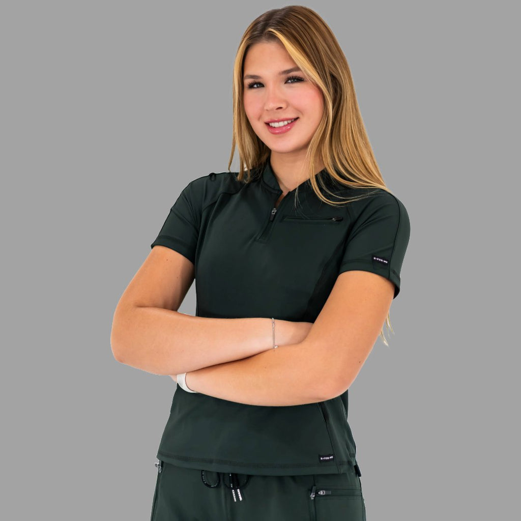 Woman with crossed arms wearing a bottle green 920 super stretch scrub top, angled right.