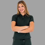 Woman with crossed arms wearing a bottle green 920 super stretch scrub top, smiling.