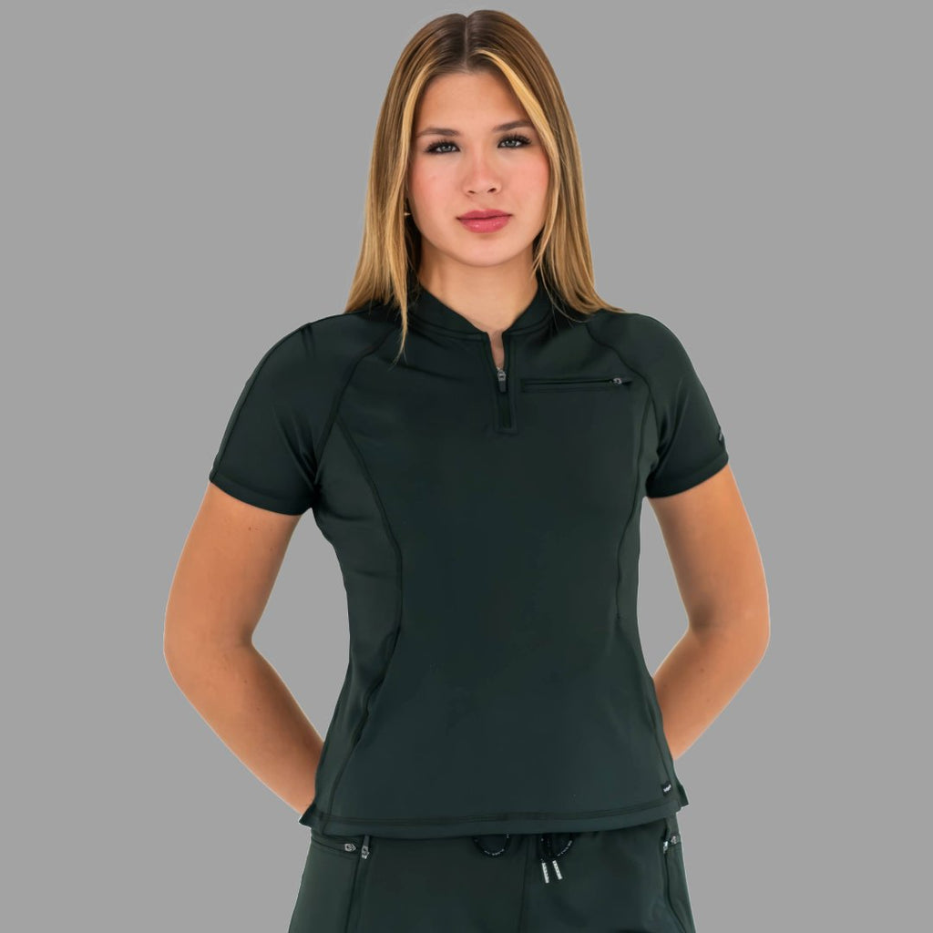Woman posing with hands behind back in a bottle green 920 super stretch scrub top.