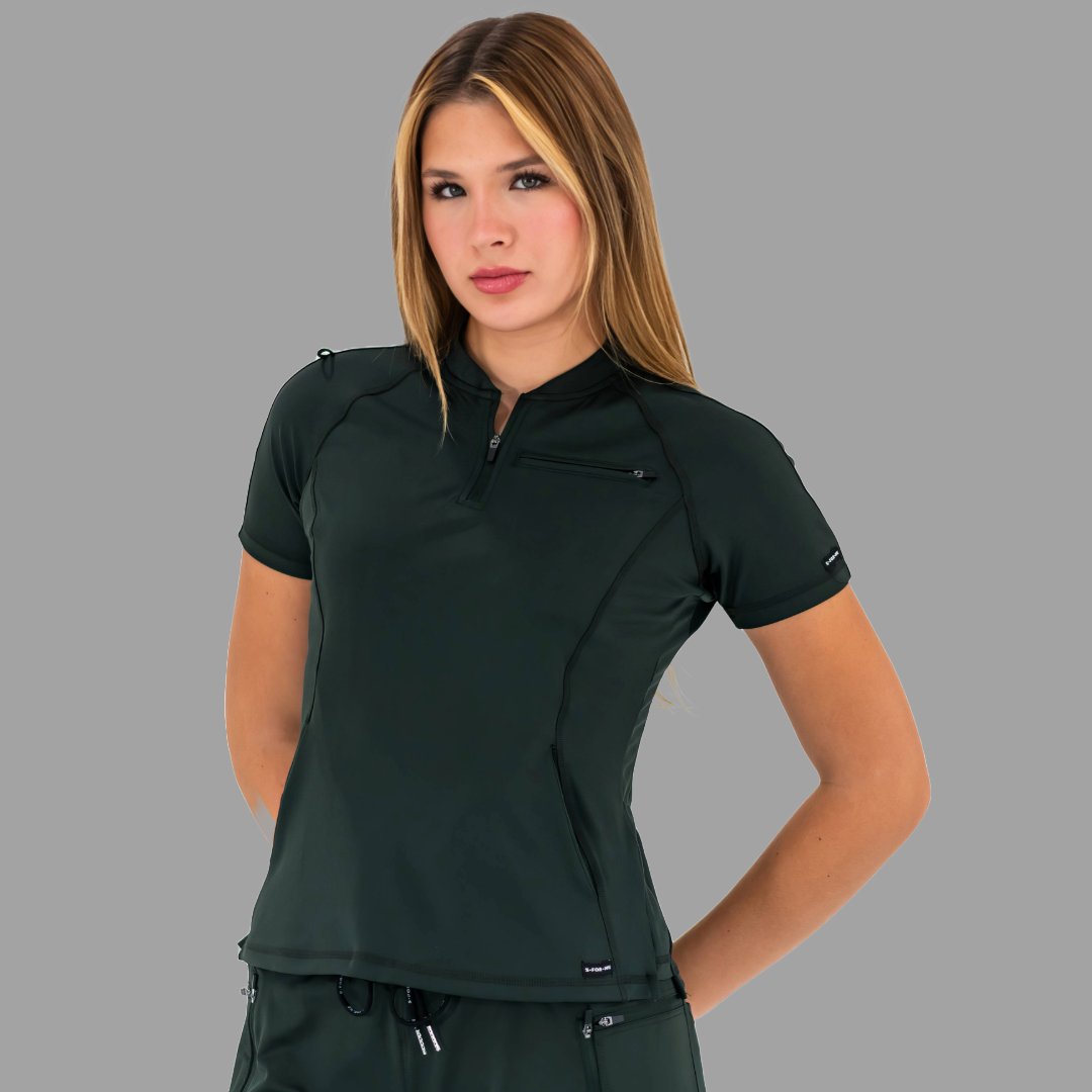 Woman wearing a bottle green 920 super stretch scrub top with hands on hips, facing forward.