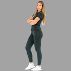 Full body side view of a woman in a bottle green 920 super stretch scrub top and pants.
