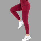 Front view of burgundy women's joggers 920 with one leg raised, showing side pockets.