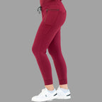 Side view of burgundy women's joggers 920, showing right leg stepping forward.