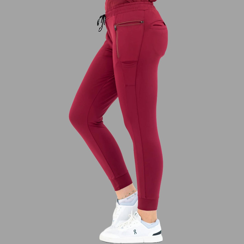 Side view of burgundy women's joggers 920, showing right leg forward.