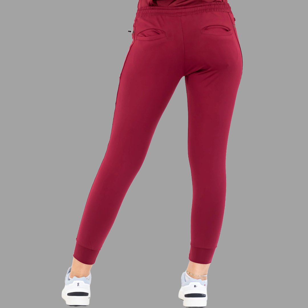 Back view of burgundy women's joggers 920, legs spread apart.