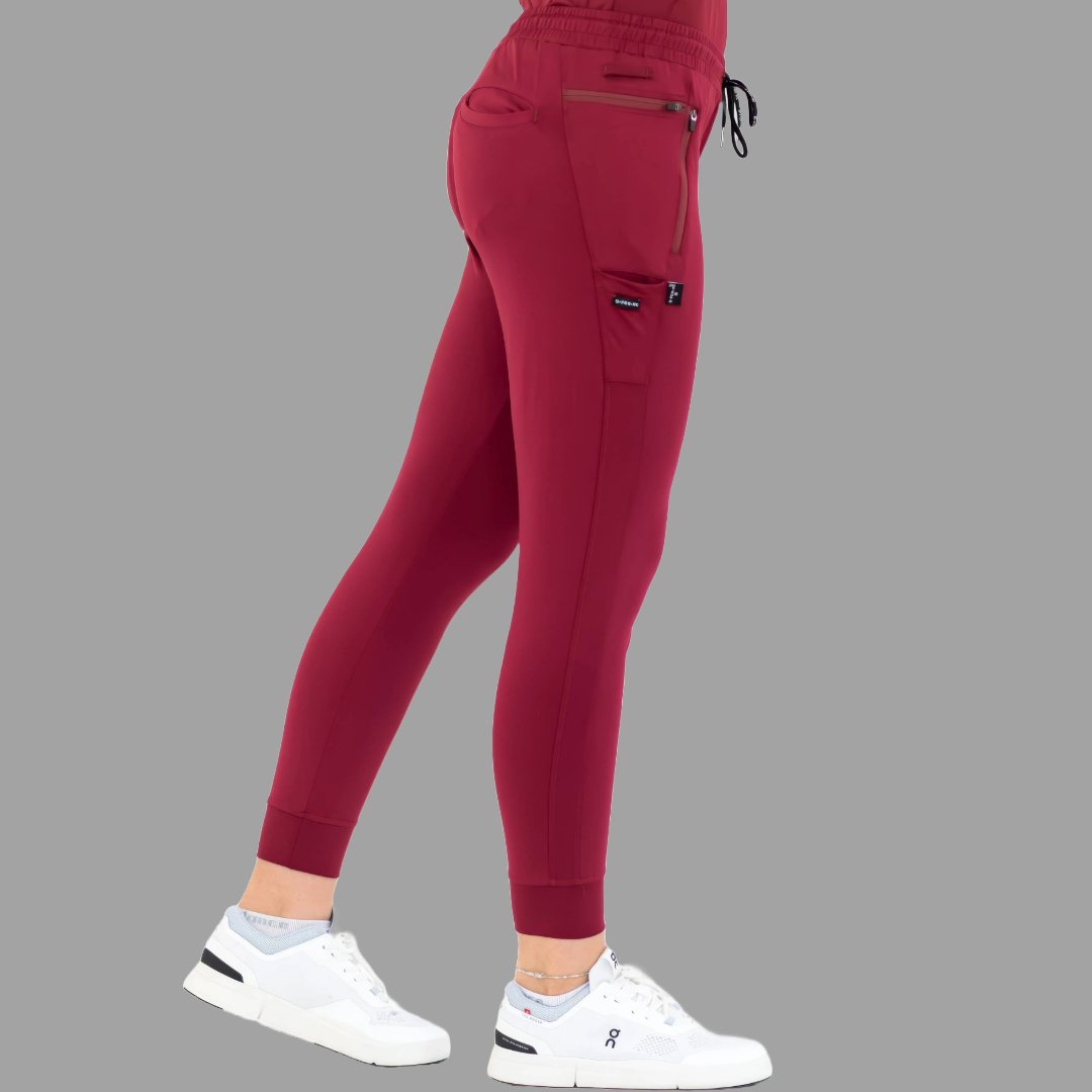 Side view of burgundy women's joggers 920, showing left leg forward.