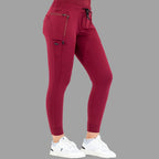 Side view of burgundy women's joggers 920, left leg slightly forward.