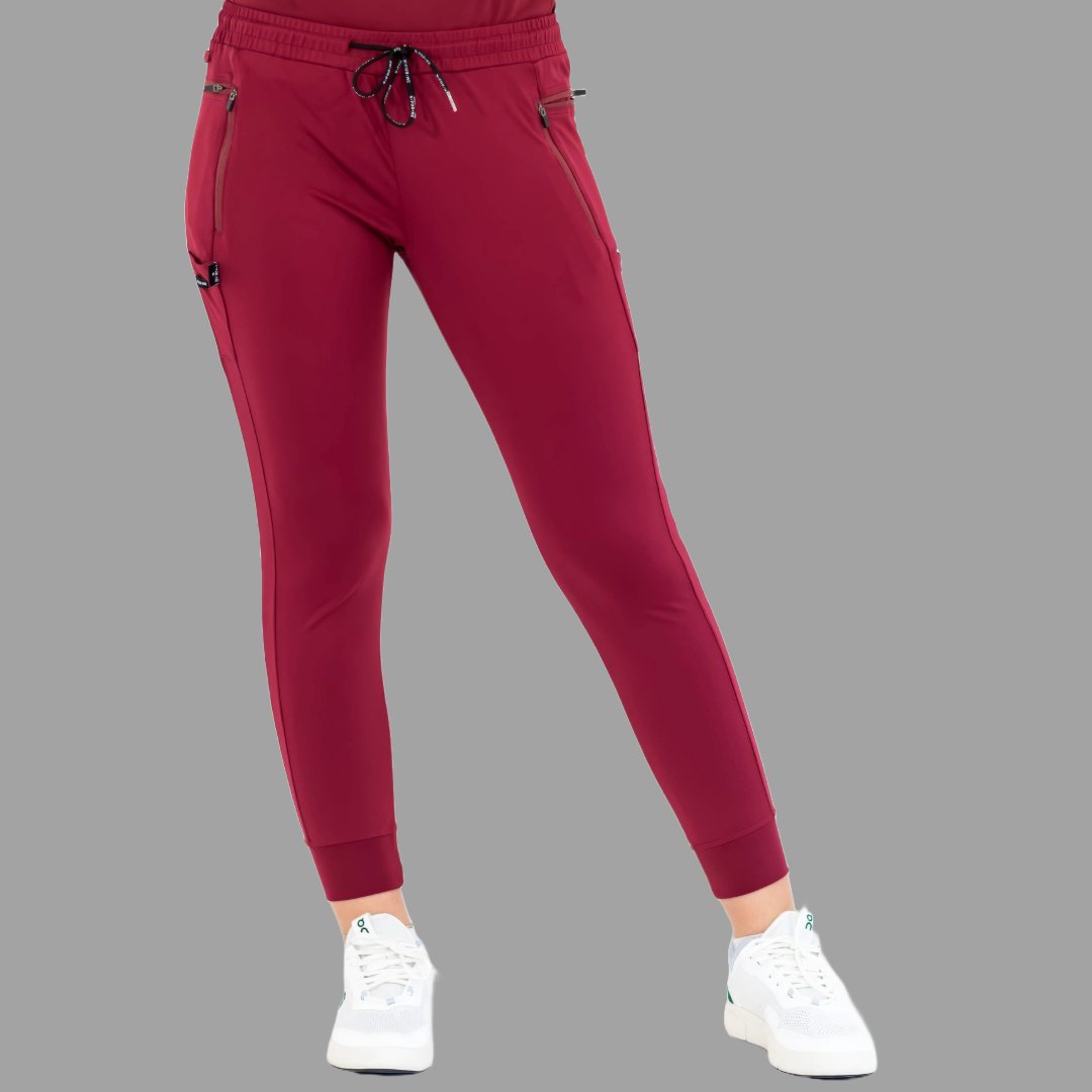 Front view of burgundy women's joggers 920, legs spread apart.