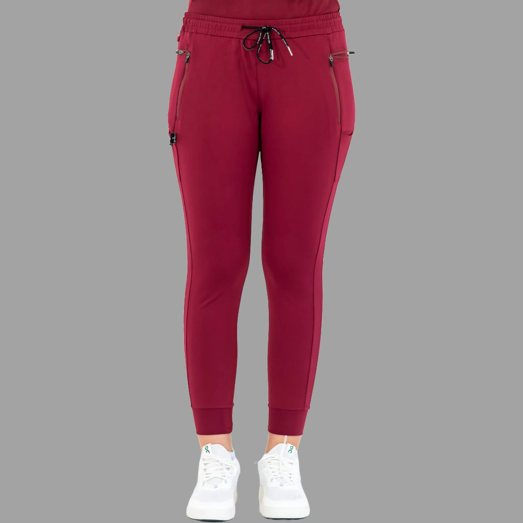 Back view of burgundy women's joggers 920, standing with feet together.